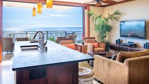 a kitchen and living room with a view of the ocean at Ko Olina Beach Villas B609 in Kapolei