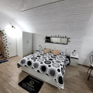 a bedroom with a bed with a black and white comforter at I Gradini dell Eden in Naples
