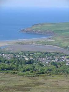 an aerial view of a town and a body of water at 32 Maescurig in Newport Pembrokeshire