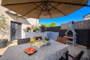 a table with a bowl of food and an umbrella at VILLA LATINI - Ideal for a family vacation. Heated pool. Local breakfast optional available in Svetvinčenat