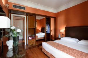 a hotel room with a large bed and a bedroom at Grand Hotel Adriatico in Florence