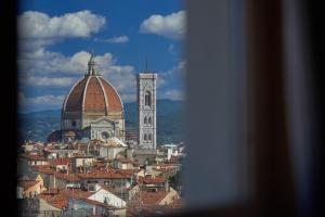 a view of a city with a cathedral and a building at Grand Hotel Adriatico in Florence