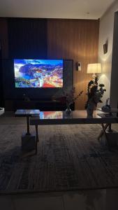 a living room with a large flat screen tv at أجنحه الفرسان الفاخره in AlUla