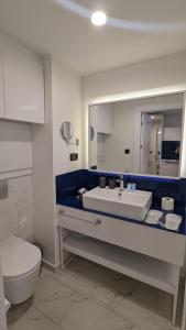 a bathroom with a sink and a toilet and a mirror at Orbi City, block C in Batumi +34 photos