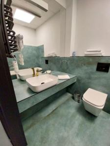 a bathroom with a sink and a toilet at Zlatarooms 310 in Warsaw