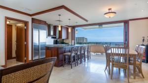 a kitchen and dining room with a view of the ocean at Ko Olina Beach Villas B701 in Kapolei