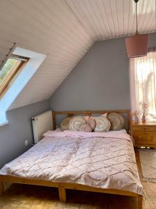 a bedroom with a bed in a attic at Przylesie 4 in Więckowice
