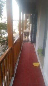 a hallway with a red carpet on a balcony at Chez Bussy in Puducherry