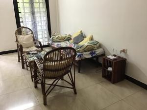 a living room with a couch and chairs and a table at Chez Bussy in Puducherry