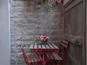 a picnic table with a potted plant on it next to a wall at I Host Apartment - Forlanini 1 in Milan