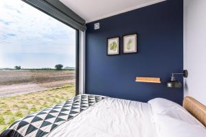 a bedroom with a bed and a large window at the BOX BNB in Wilton