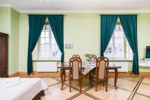 Apartamenty w Pałacu Pod Baranami في كراكوف: غرفة طعام مع طاولة وكرسيين