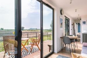 a room with a sliding glass door with a view of the field at the BOX BNB in Wilton