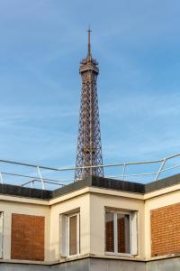 a building with a tower on top of it at The Carla Suite Eiffel Tower View in Paris