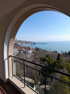 a view of the ocean from a balcony at Queen's Palace Balchik apartment in Balchik