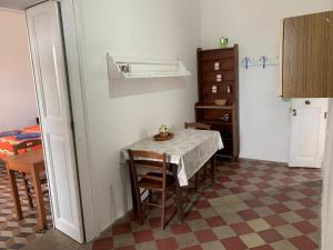 - une salle à manger avec une table, une table et des chaises dans l'établissement Case La Pergola, à Stromboli