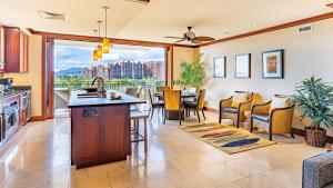 a kitchen and living room with a table and chairs at Ko Olina Beach Villas B706 in Kapolei