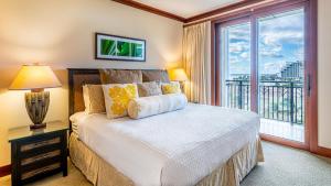 a bedroom with a bed and a large window at Ko Olina Beach Villas B706 in Kapolei +32 photos