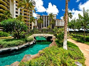 a bridge over a river in front of a building at Ko Olina Beach Villas B706 in Kapolei