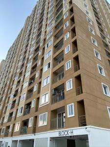 a tall building with windows and balconies at Sri Sai 3 BHK Home in Kelambākkam