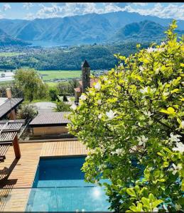a villa with a swimming pool and mountains in the background at La Villa with heated pool and amaizing view in Cademario