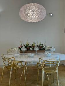 a dining room table with chairs and a chandelier at Home suite Home in Avellino