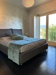 a bedroom with a bed and a large window at Home suite Home in Avellino