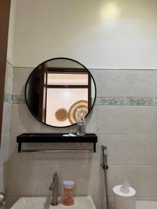 a bathroom with a mirror above a sink at Oceana Bay Coron in Coron