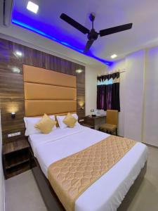 a bedroom with a large bed with a blue ceiling at Hotel Blue Wellington - Near Mumbai Airport in Mumbai