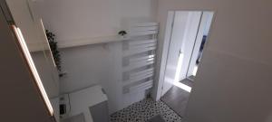a small bathroom with white walls and a window at Apartment Horizont in Bad Sachsa