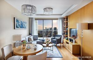 a living room with a couch and a table in a room at Savills Residence Daxin Shenzhen Bay in Shenzhen