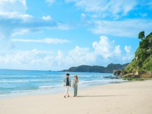 a man and a woman walking on the beach at Shimoda Prince Hotel in Shimoda +110 photos
