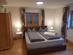un grande letto in una stanza con due tavoli di Ferienwohnung am Stießberg a Oberstaufen