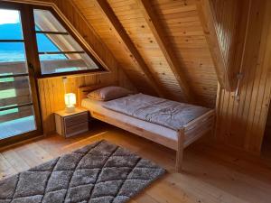 A bed or beds in a room at Vikendica Ivana