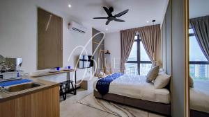 a bedroom with a bed and a kitchen with a sink at Neu Suites Premier Suites by BlueBanana in Kuala Lumpur