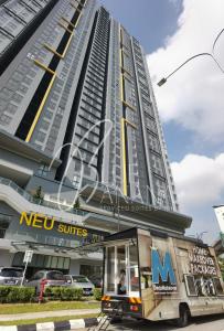 a moving truck parked in front of a building at Neu Suites Premier Suites by BlueBanana in Kuala Lumpur
