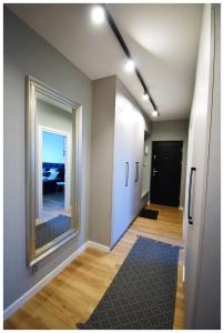 an empty hallway with a large mirror and a room at Color 24 Prestige in Stalowa Wola