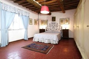 a bedroom with a bed and a large window at Apartment in Sovicille with heating in Sovicille