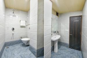 a bathroom with a toilet and a sink at FabHotel Ess Pee Grand in Mohali