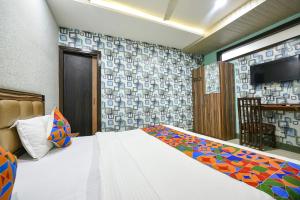 a bedroom with a bed and a flat screen tv at FabHotel Ess Pee Grand in Mohali