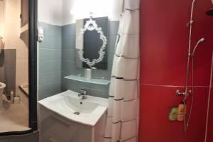 a bathroom with a sink and a mirror at Le Nid Douillet Baroque Linge fourni in La Bourboule +5 photos