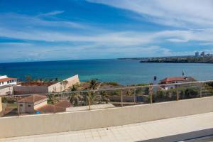 a view of the ocean from a balcony at A Cozy Two Bedroom Sea View Apartment With a Pool and 3 Beds in Mombasa