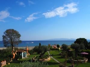 a view of a garden with the ocean in the background at Medusa Gorgon in Develíkia