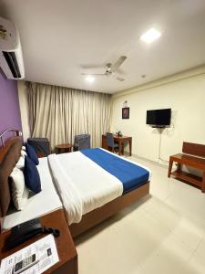 a bedroom with a bed and a flat screen tv at Hotel Divine Admire Opp Gurudwara Sahib in Taimoor Nagar-Friends Colony in New Delhi