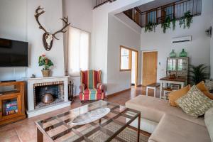 a living room with a couch and a fireplace at Casa los Jardines del Lago in Córdoba