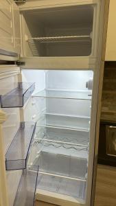 een lege koelkast met de deur open in een keuken bij Appartamenti Yolanda in Rozzano