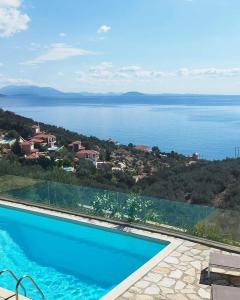 a swimming pool with a view of the water at Apollo Romantic Sea View Villa in Kiveri