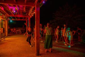 a group of people walking around a party at night at LA FONTAINE D'ANNIBAL in Buis-les-Baronnies +47 photos