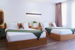 Postel nebo postele na pokoji v ubytování Phuc Lam Hotel & Apartment