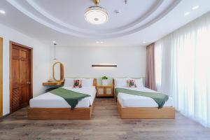 Postel nebo postele na pokoji v ubytování Phuc Lam Hotel & Apartment